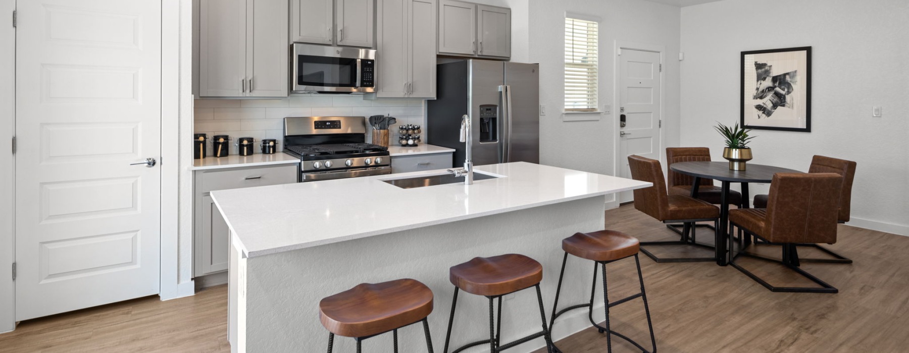 Kitchen with island and dining room in 2 bedroom townhomes for rent