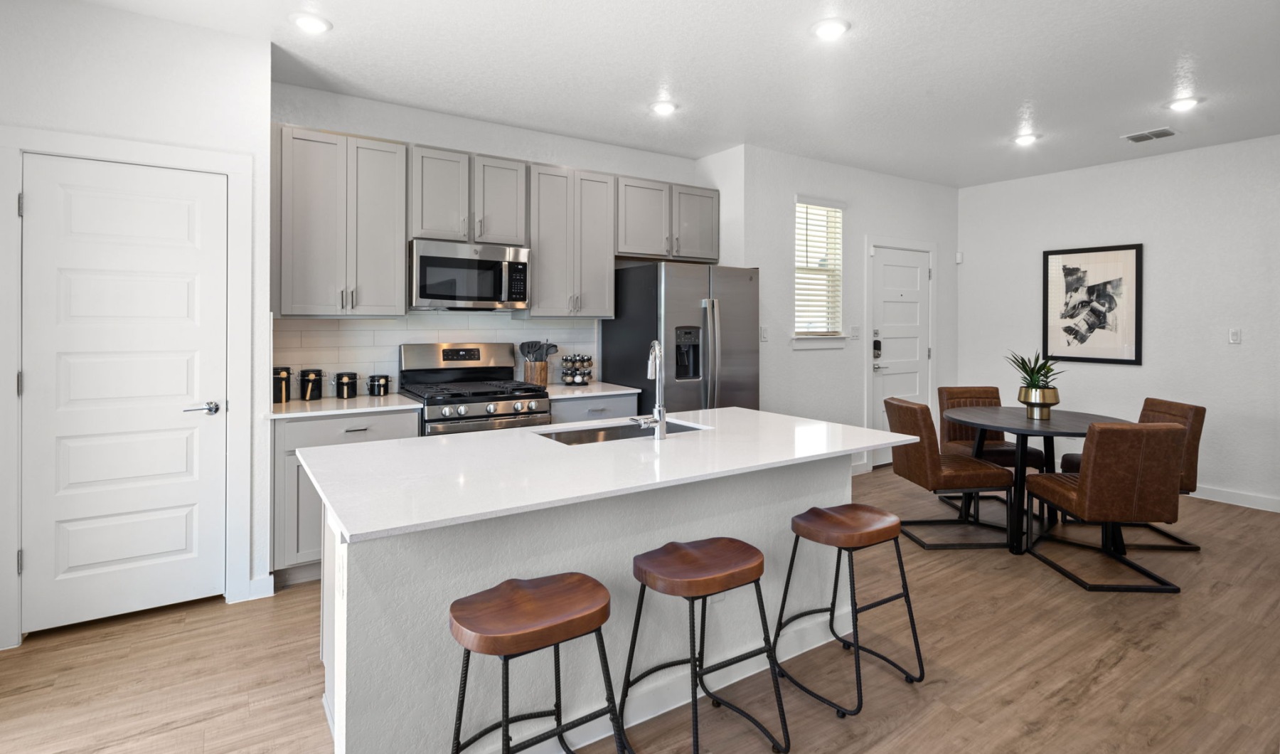 Kitchen with island and dining room in 2 bedroom townhomes for rent
