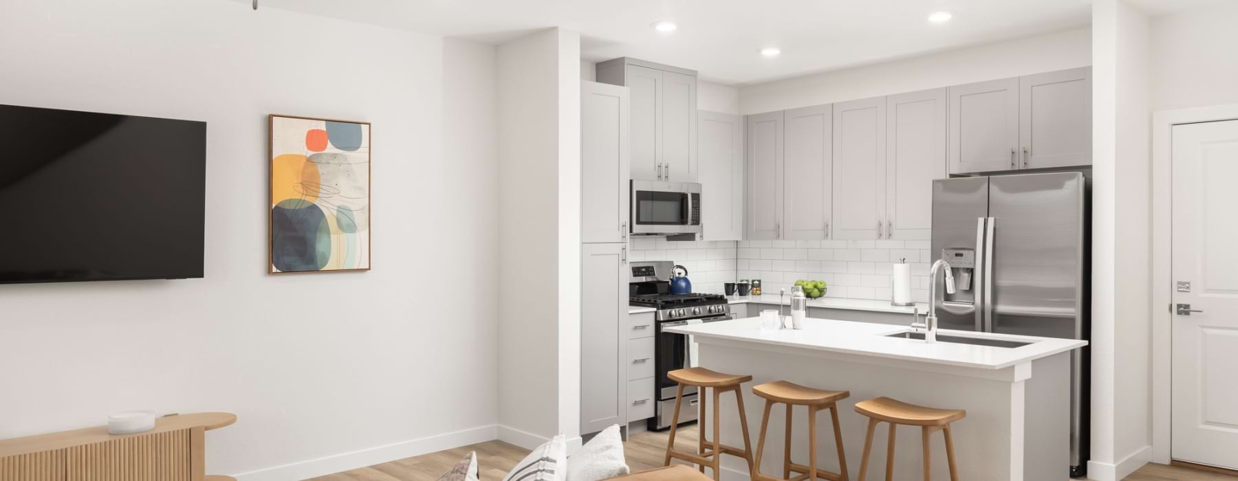 Kitchen with island, stainless steel appliances and gas stove
