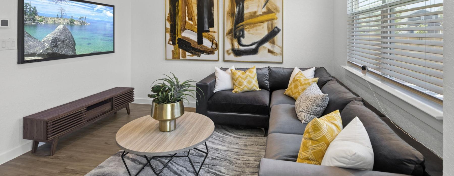 a living room with a couch and a table and tv