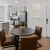 a kitchen beyond a dining table and chairs