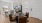 a kitchen beyond a dining table and chairs