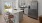 a kitchen with white cabinets a white island a fridge a sink and a stovetop