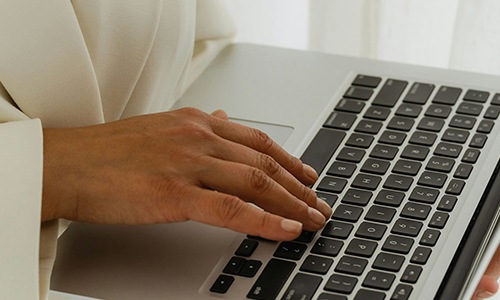 persons hands on a laptop computer